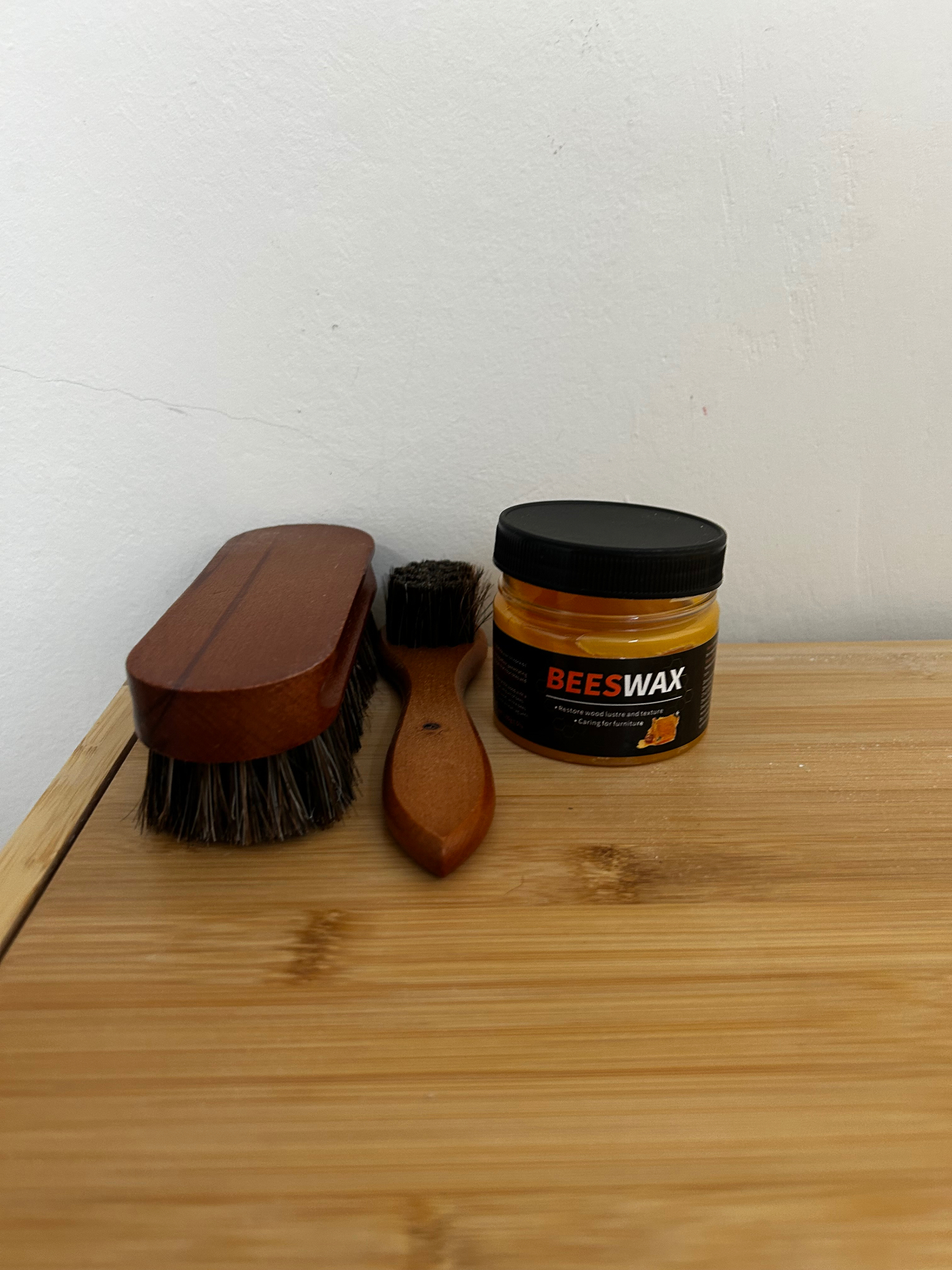 Wooden brushes and a jar of beeswax for caring for the wooden furniture